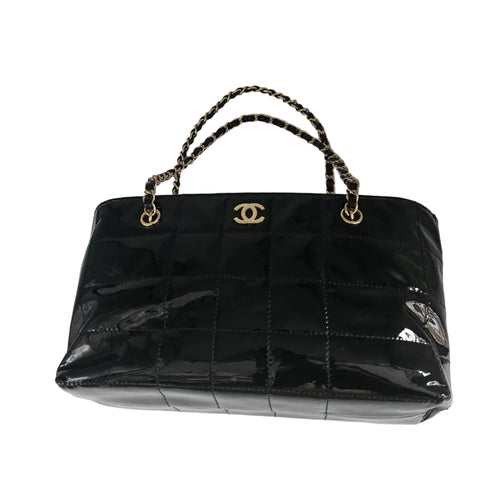A black patent leather Chanel handbag with a quilted texture, gold-tone CC logo clasp, and a black-and-gold chain handle, shown on a light gray background.