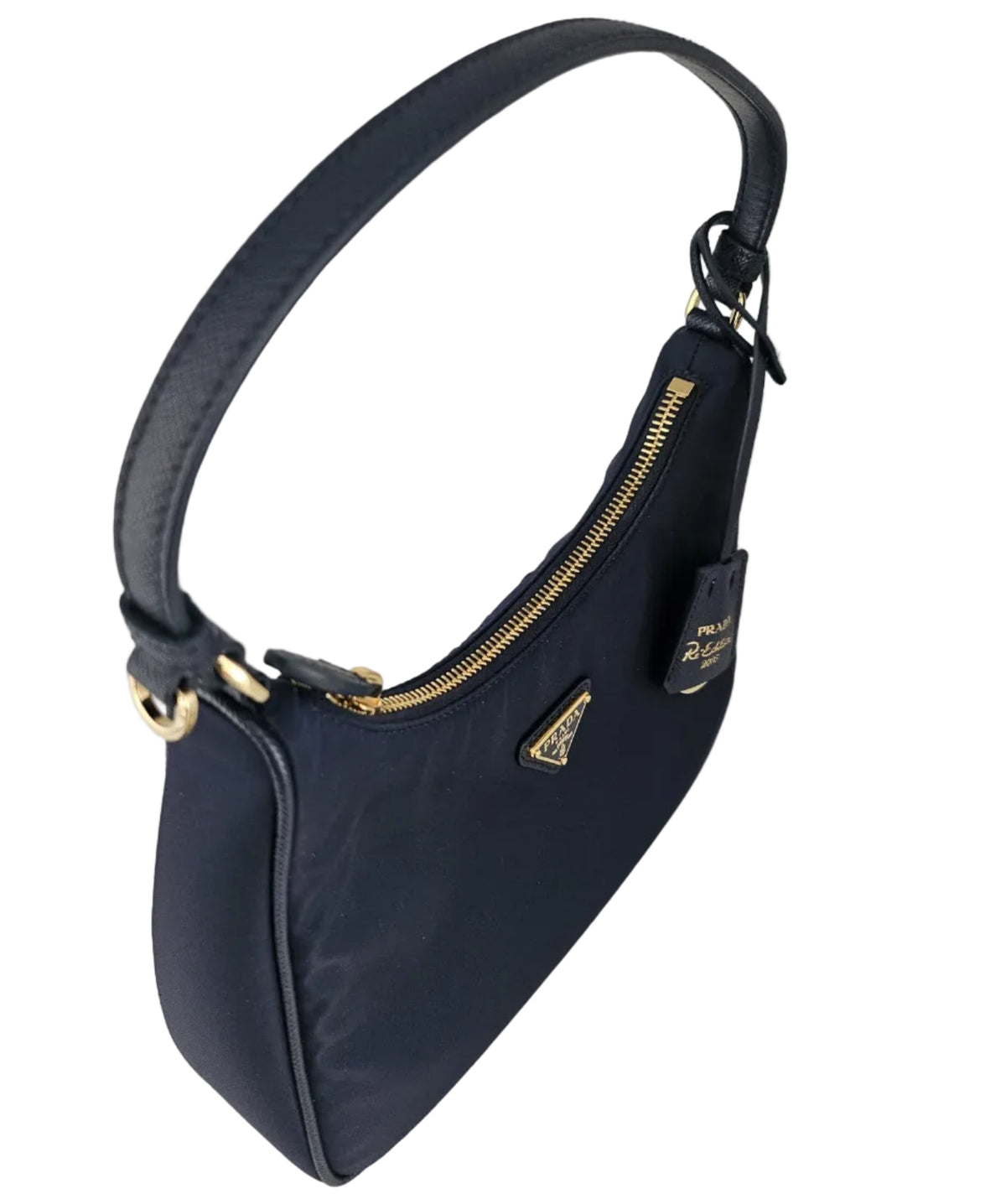 A navy blue nylon shoulder bag with gold-tone hardware, a top zipper, and a small triangular Prada logo plaque on the front, photographed on a light gray background.
